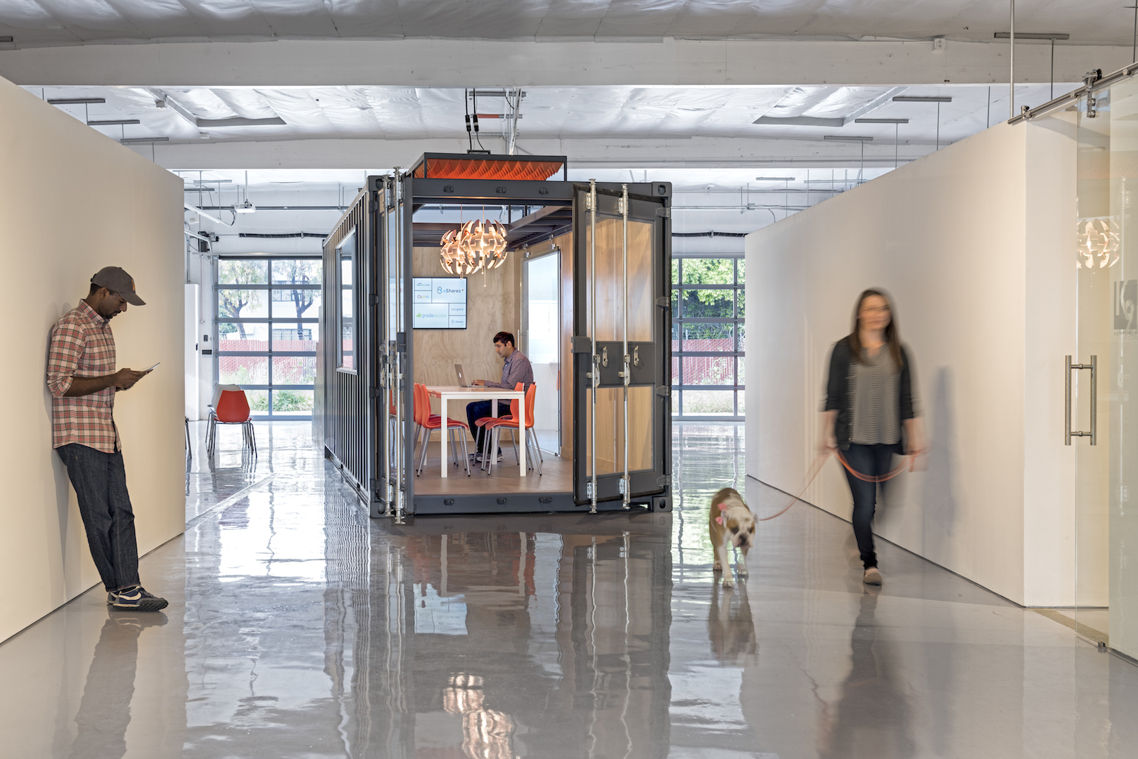 Light permeates the space via the roll up glass garage doors in the rear.